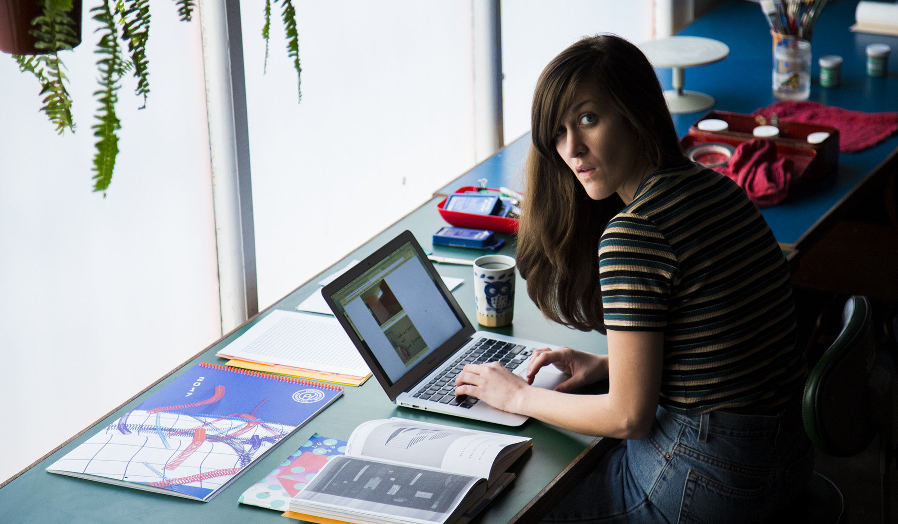 <h4 >Name:</h4><p>Adi Goodrich</p>  <h4 >What’s on your desk?</h4> <p>A scanner, an iMac, a stack of envelopes to mail out to friends, a sketchbook, a ruler, a screwdriver, A Dieter Rams book, headphones, a mug from japan with cats on it.</p>  <h4 >Fill in the blank: "I don't show up at a meeting without _________."</h4> <p>a sketchbook</p>  <h4 >What's on your reading list?</h4> <p  style="margin-bottom:35px;">The Bauhaus Group: Six Masters of Modernism, Apartamento, Leap Before You Look: Black Mountain Co