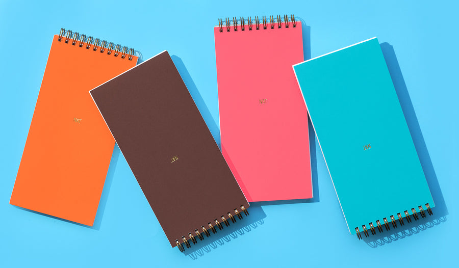 Based on the format of the traditional reporter's notebook, Commune's Designer's Notebooks add beauty to functionality with brightly colored covers in premium Astrobright papers and custom gold monogramming. Sold in sets of four with one each of Orbit Orange, Rocket Red, Terrestrial Teal, and Jupiter Java colored covers. Approximately 90 lined pages per notebook.