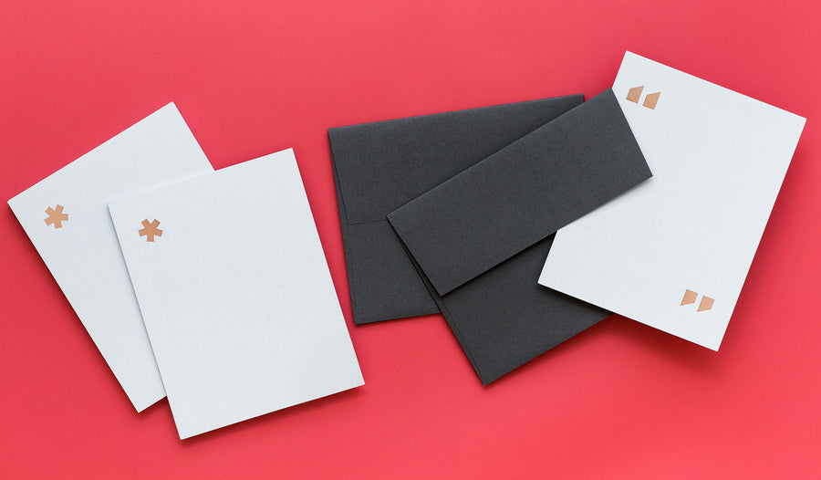 Simple elegance abounds in these notecard sets from fashion brand and retailer Everlane. Featuring double thick grey paper with rose gold foil stamping in three graphic options including quotation marks, parentheses, and an asterisk, these cards will frame any note in refinement. Sold in sets of ten cards with charcoal grey envelopes.
